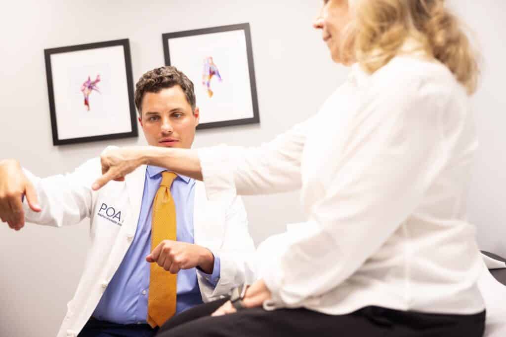 A POA hand specialist examines a patient's wrist