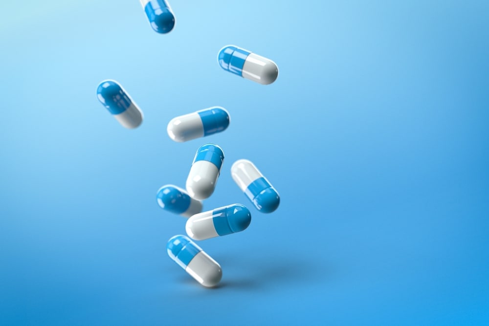 image,of,blue,pills,on,a,isolated,blue,background.,blue