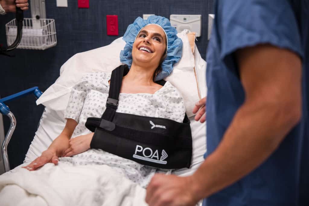 Princeton Orthopaedic Associates - 2026 - New Jersey - Front Desk-13 - Princeton Orthopaedic Associates A smiling patient in a gown and surgical cap before a procedure